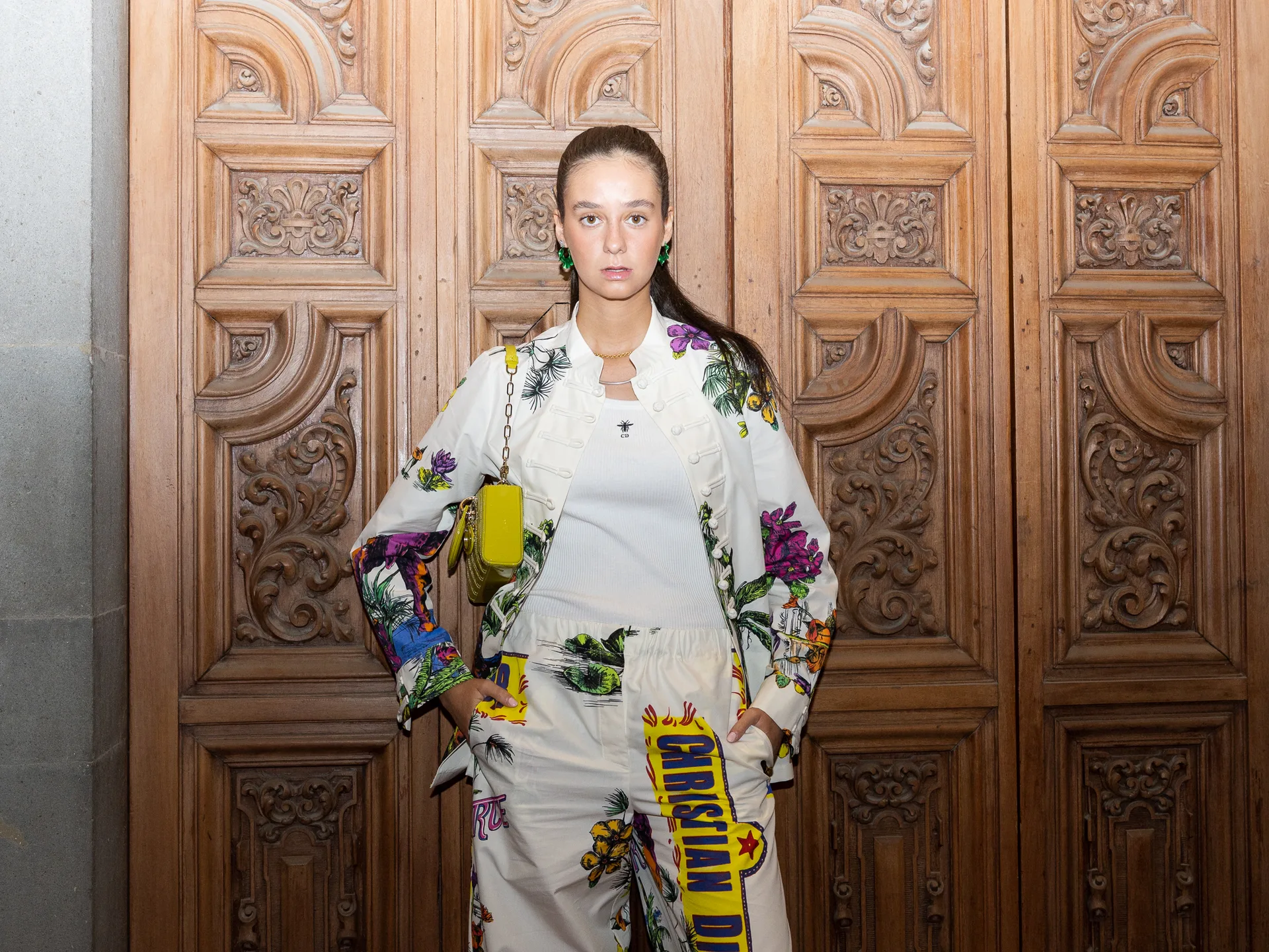 Floral suit at the carved doors